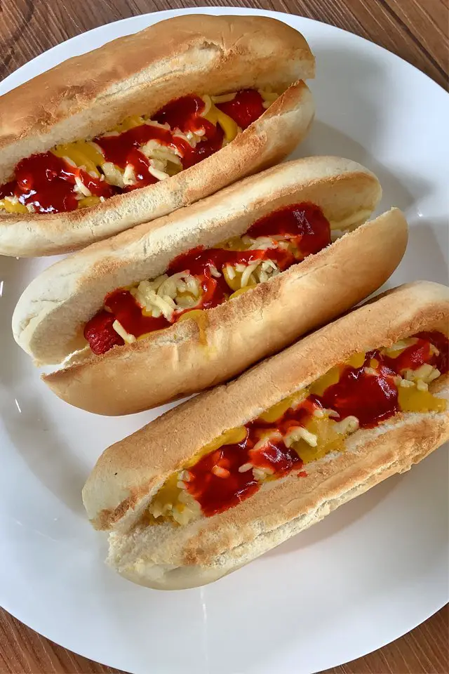frozen hotdogs in air fryer in white plate. mom food blog